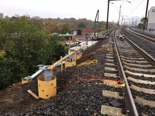 Installation of helical piles to support trough at track level along a train bridge in Woodside, Queens. (CQ033, 11-05-2017)
