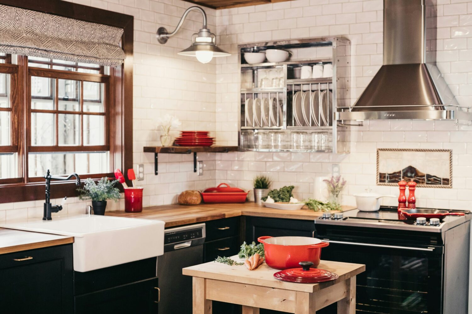 A view of modern kitchen appliances with a mosaic tile backsplash.