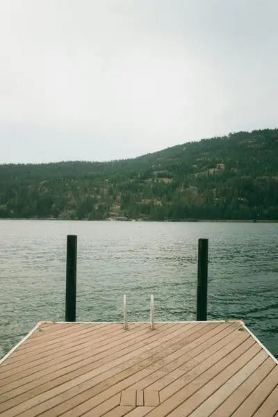 Serene lakeside view from wooden dock.