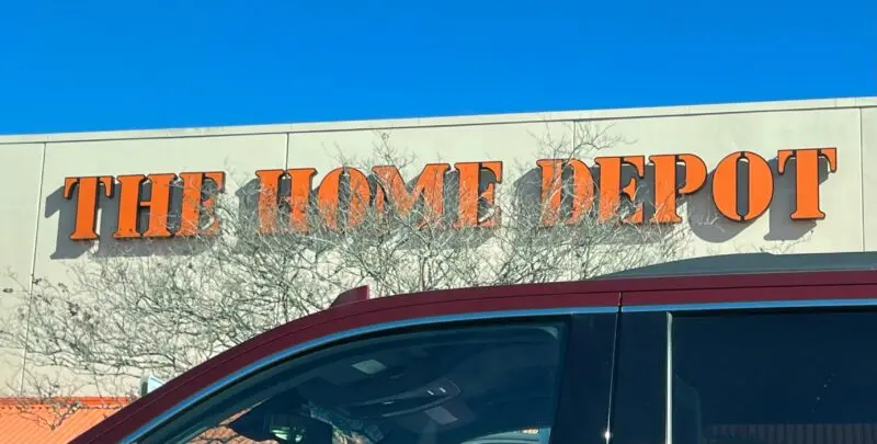 A red car parked in front of a home depot