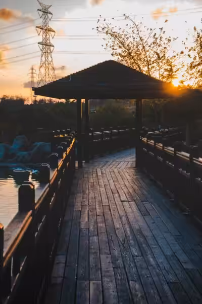 Wooden lakeside pathway with an overhanging roof