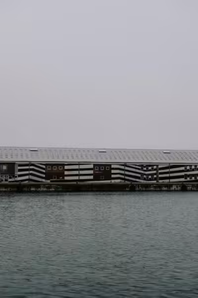 A large building sitting on top of a body of water.