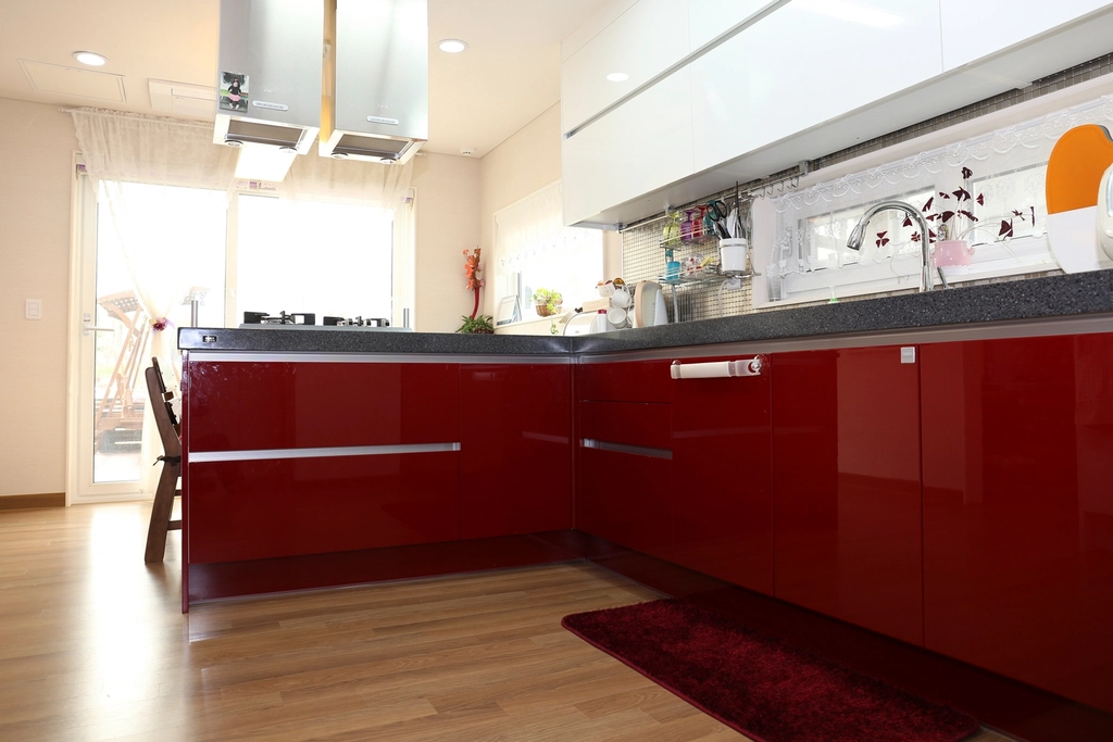 Artisanal small kitchen featuring hand-painted ceramic tile backsplash with unique patterns.