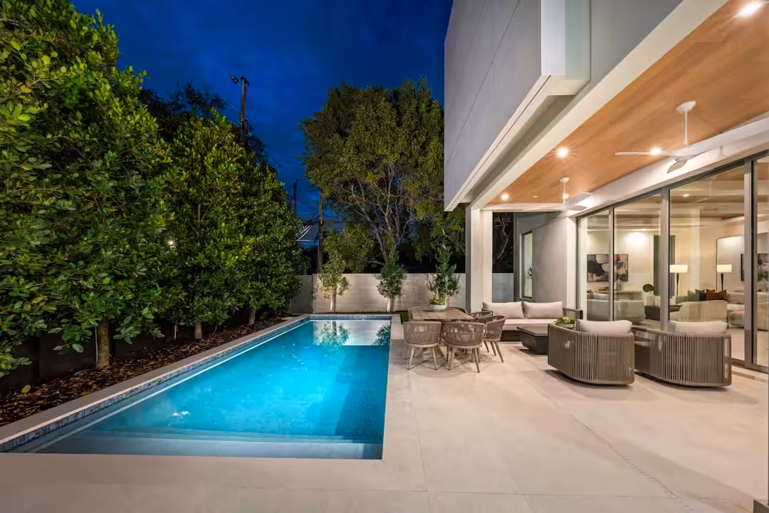Modern home with pool and outdoor seating area.