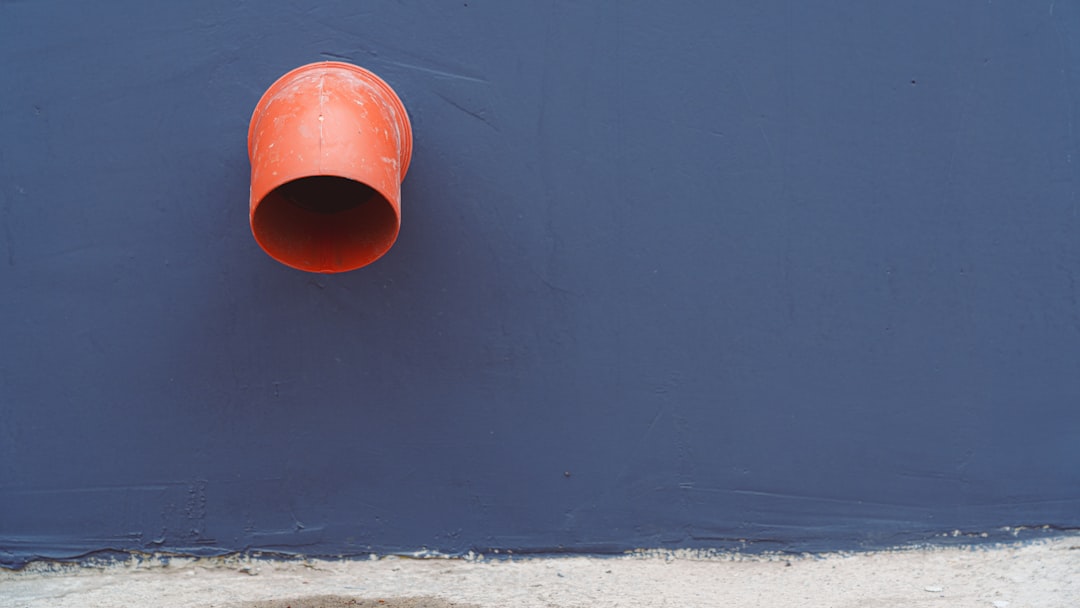 Orange pipe and blue wall.