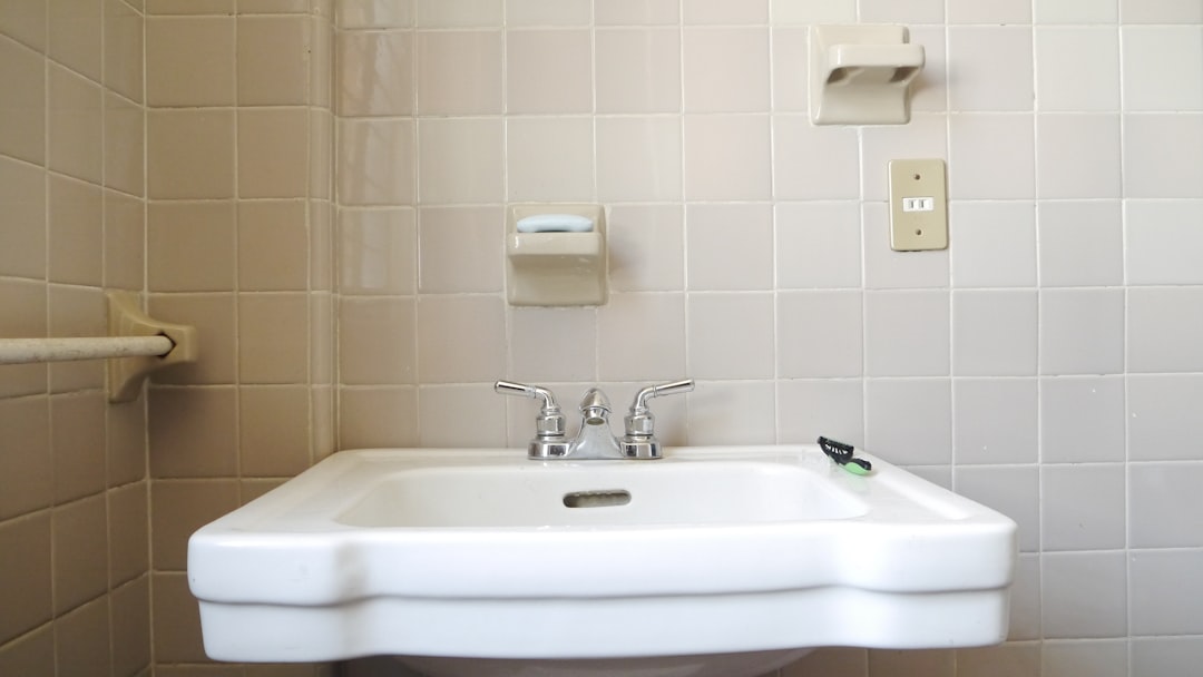 a white sink in a bathroom next to a toilet