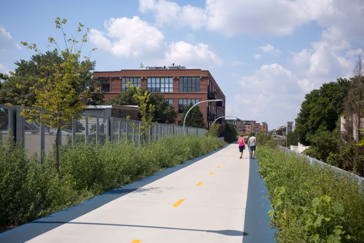 City skyline and public realm planning reference showing elevated greenway trail repurposing historic infrastructure.