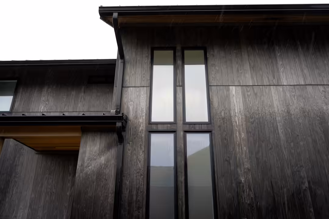 Modern building exterior with tall windows and narrow windows.