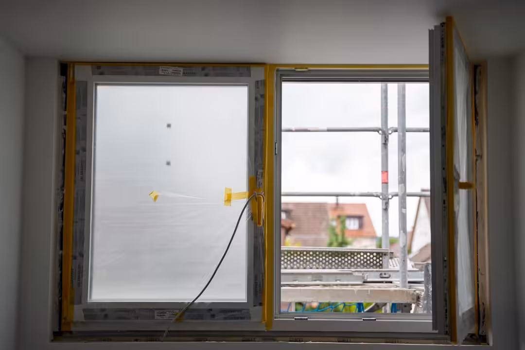 Open window with construction happening outside.