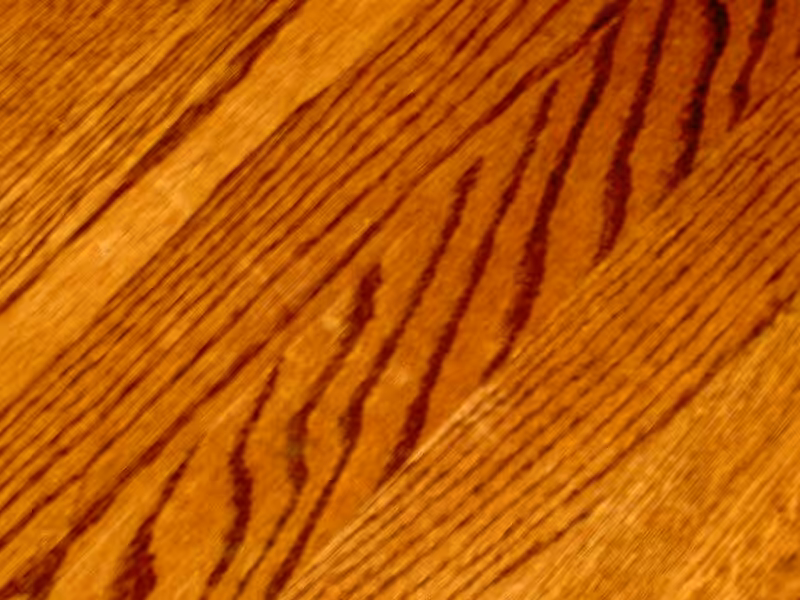 A beautifully polished wood floor with a warm finish, ideal for a cozy home.