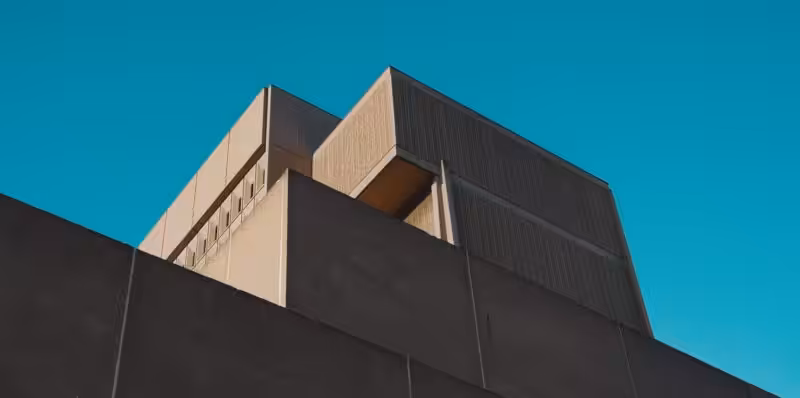 A striking view of a modern concrete structure against a vibrant blue sky in London, Ontario.