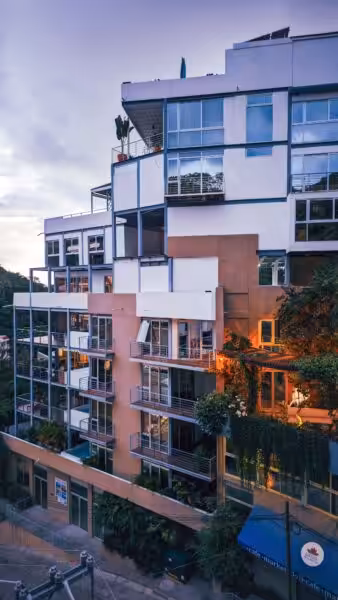 Contemporary urban apartment complex featuring modern architecture and greenery.