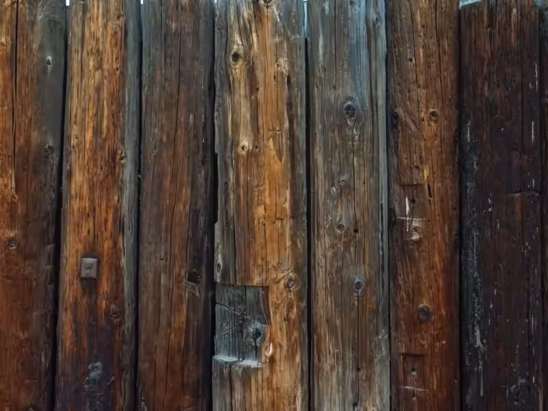 Detailed view of a rustic wooden fence showcasing weathered textures and natural grains.