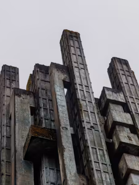 Dramatic view of a brutalist concrete structure with an overcast sky backdrop.