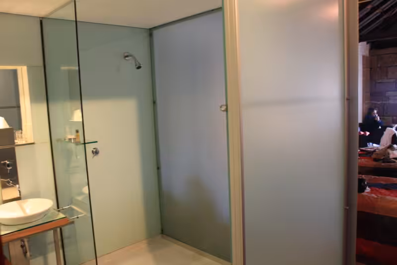 Minimalist glass walk-in shower with simple fixtures
