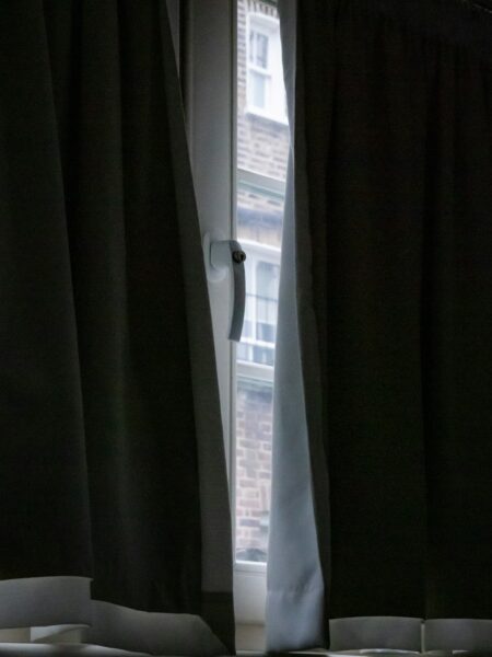 Morning light creeps in through crack between curtains.
