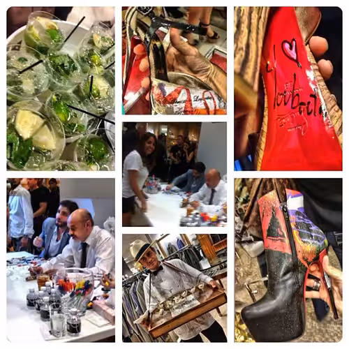 Christian Louboutin signing books at an event, representing his brand presence