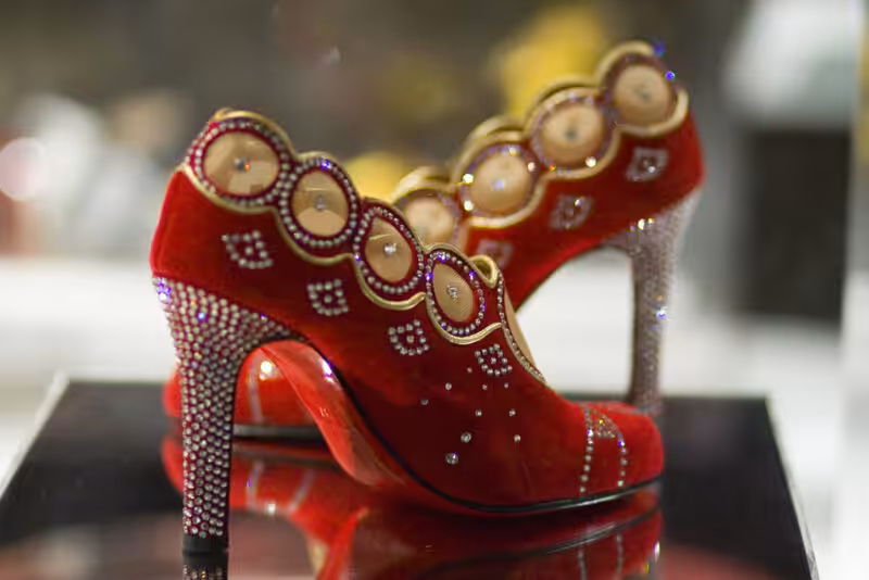 Elegant Christian Louboutin Red & Gold Pumps showcasing luxury fashion
