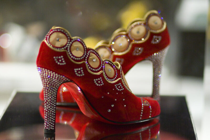 Elegant Christian Louboutin Red & Gold Pumps showcasing luxury fashion