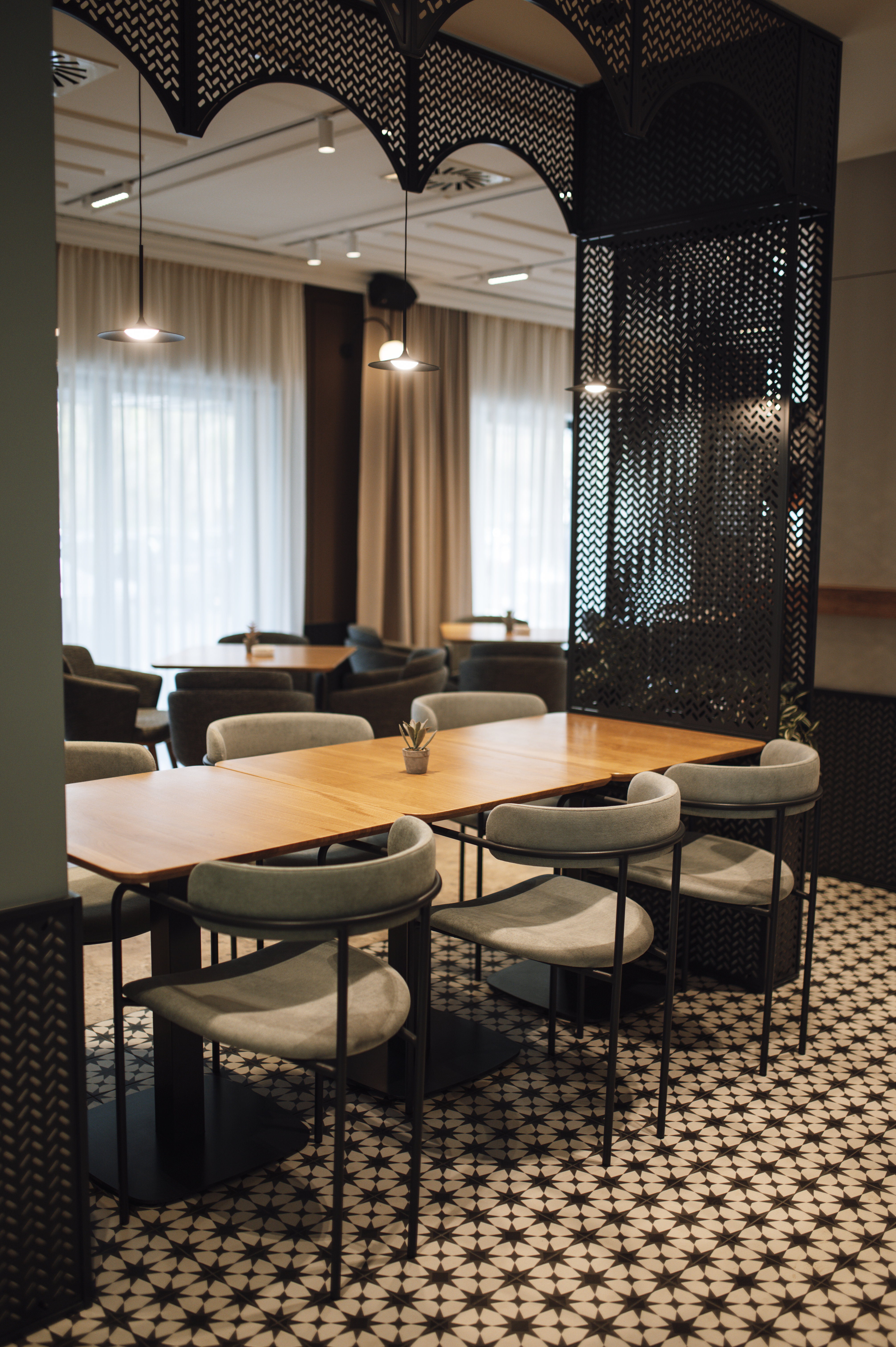 Modern cafe interior design with empty tables and stylish decor located in an urban area.