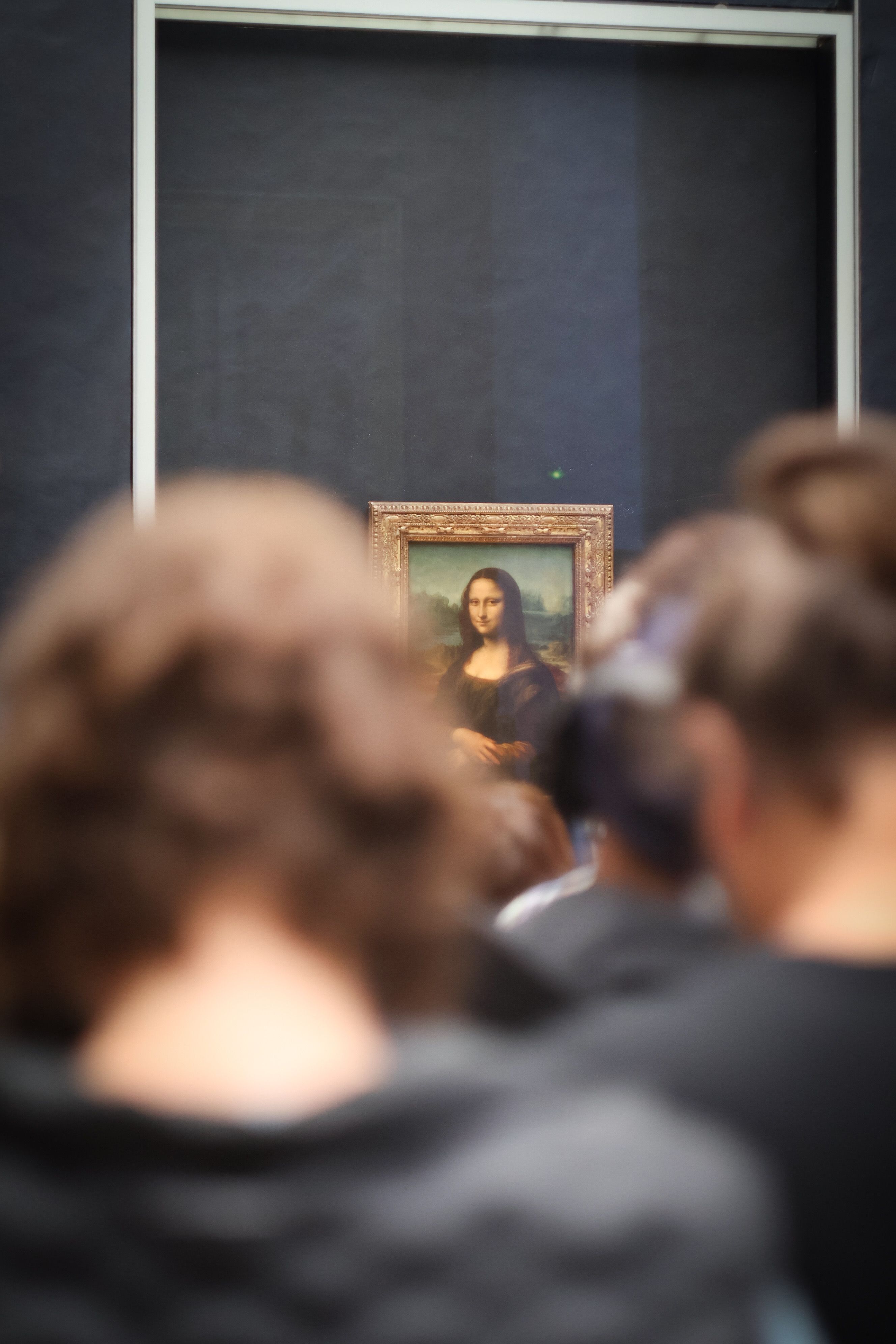 Tourists viewing the Mona Lisa at the Louvre Museum in Paris, France.