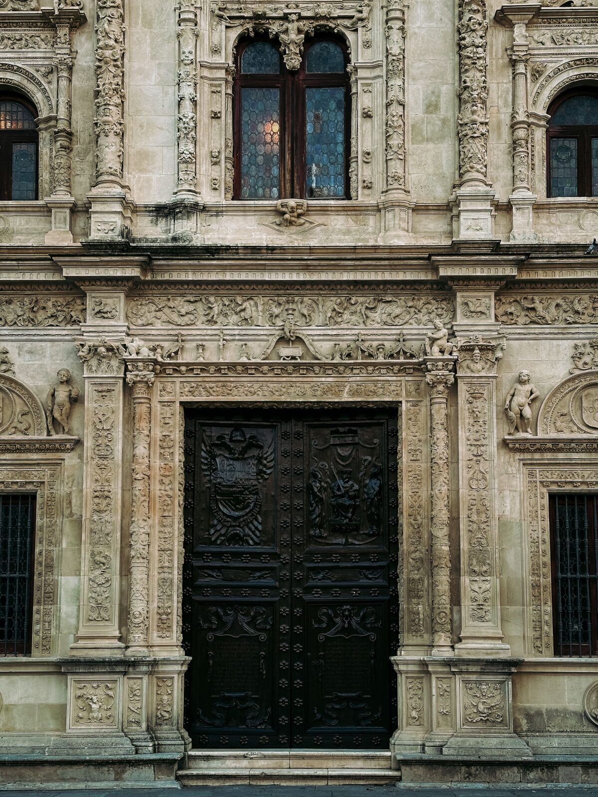 Detailed Renaissance architecture facade in Seville, showcasing intricate stone carvings and artistry.