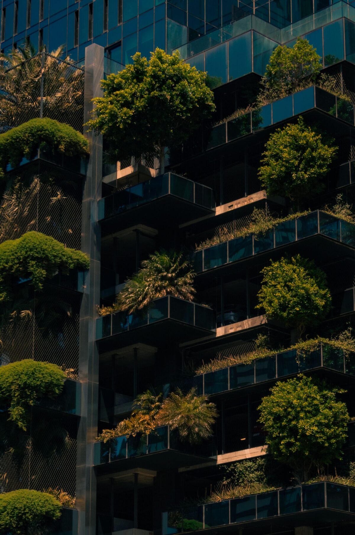 Innovative urban architecture with green vertical garden on building facade showcasing modern environmental design.