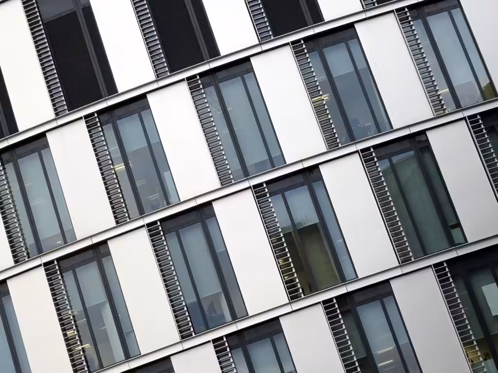 Angled view of a modern office building with large glass windows and steel accents.