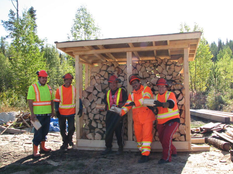 Community partners working together, fostering ideas around shed construction and resource management for local needs.