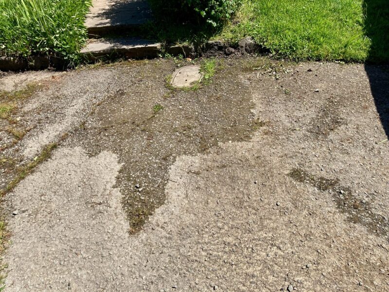 Water leaking from a toilet flange area with visible damage.