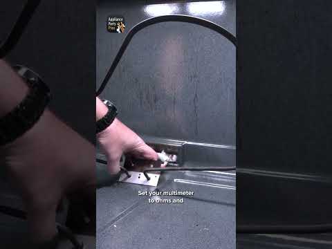 Person testing an oven bake element