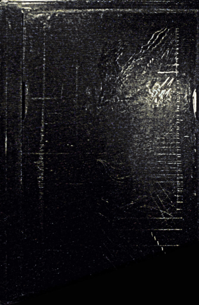 A glass plate covered with black mastic