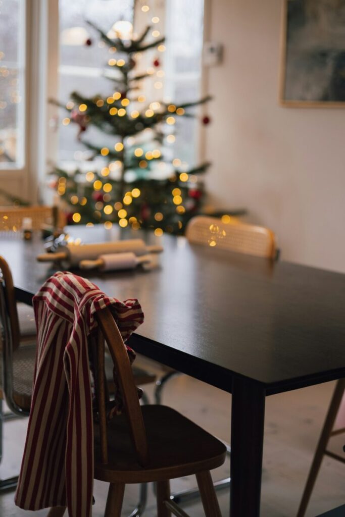 Christmas tree and dining table with striped cloth.