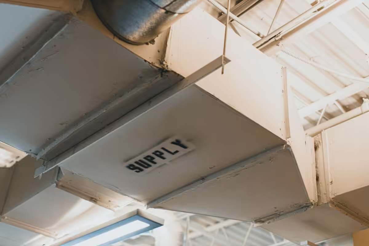 Close-up view of an air duct labeled