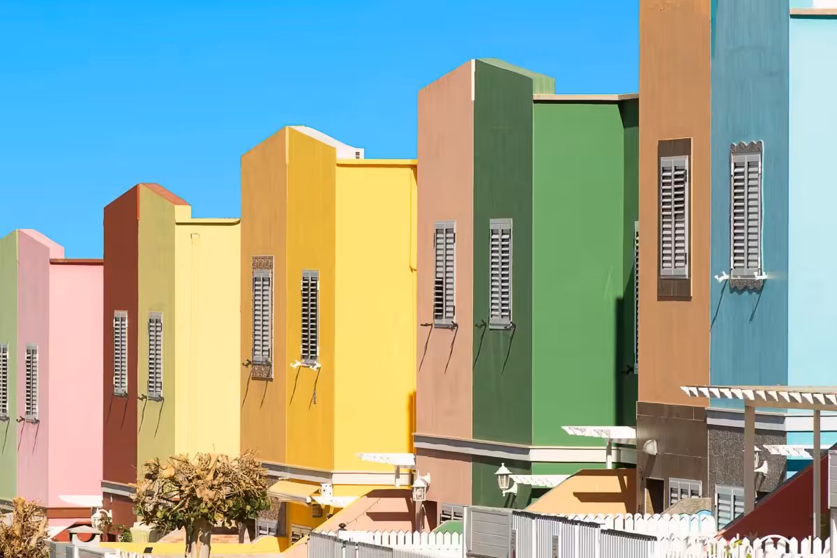 Vibrant and modern villas in a sunny suburban setting, showcasing diverse architectural facades.