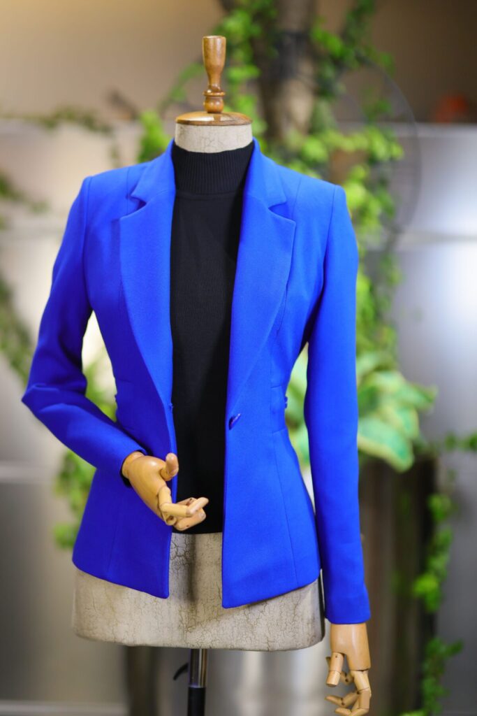 Stylish royal blue tailored blazer displayed on mannequin indoors.